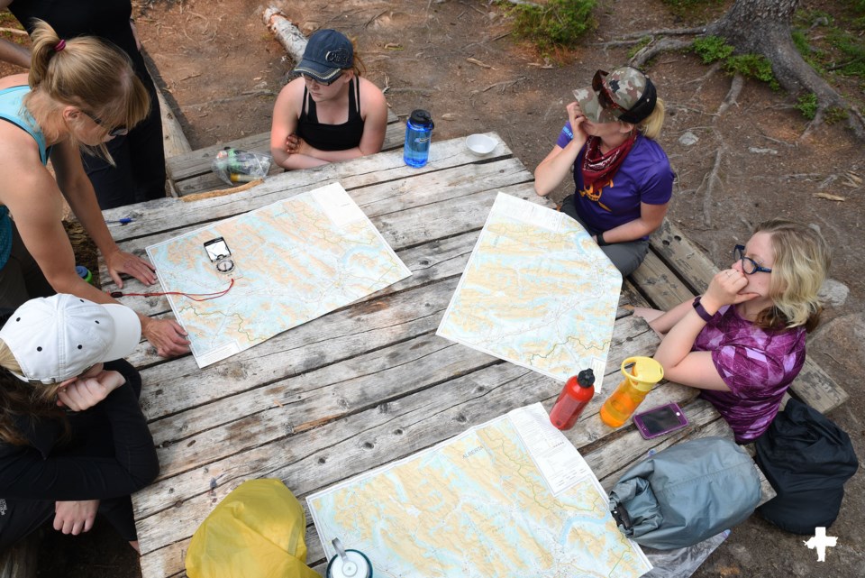 GetOutside-NavigationCourse-women-maps-compass-camping-picnic-table