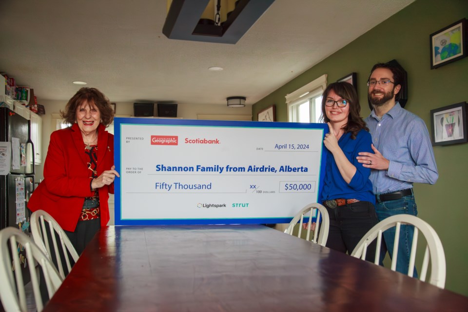 After winning Canada's net zero challenge, Samantha and Kevin Shannon received their reward of $50,000 by Honourary President of Canadian Geographic, the Hon. Lois Mitchell.