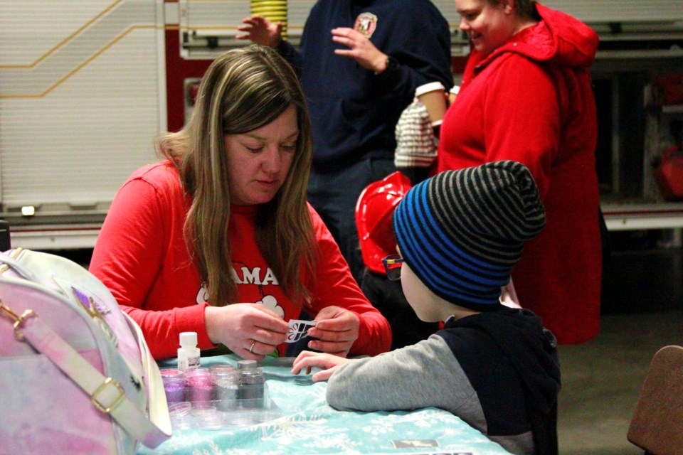Glitter tattoos in the making at the Beiseker Fire hall during Christmas in the Village on Dec. 2.