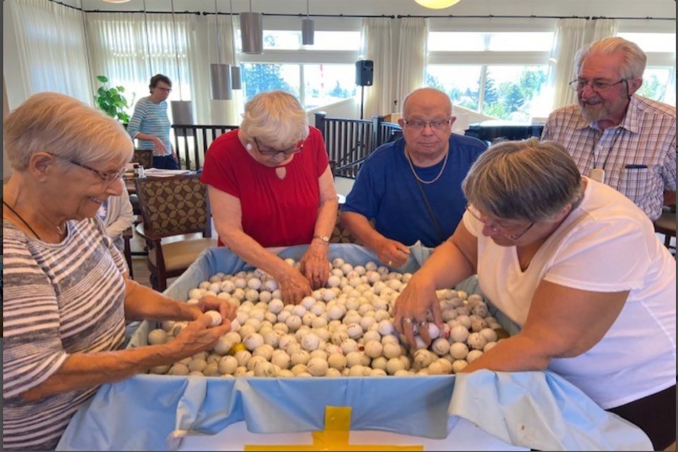 During the month-long Amazing Race competition, competitors had to sift through 500 golf balls to find two with their team name on it. 