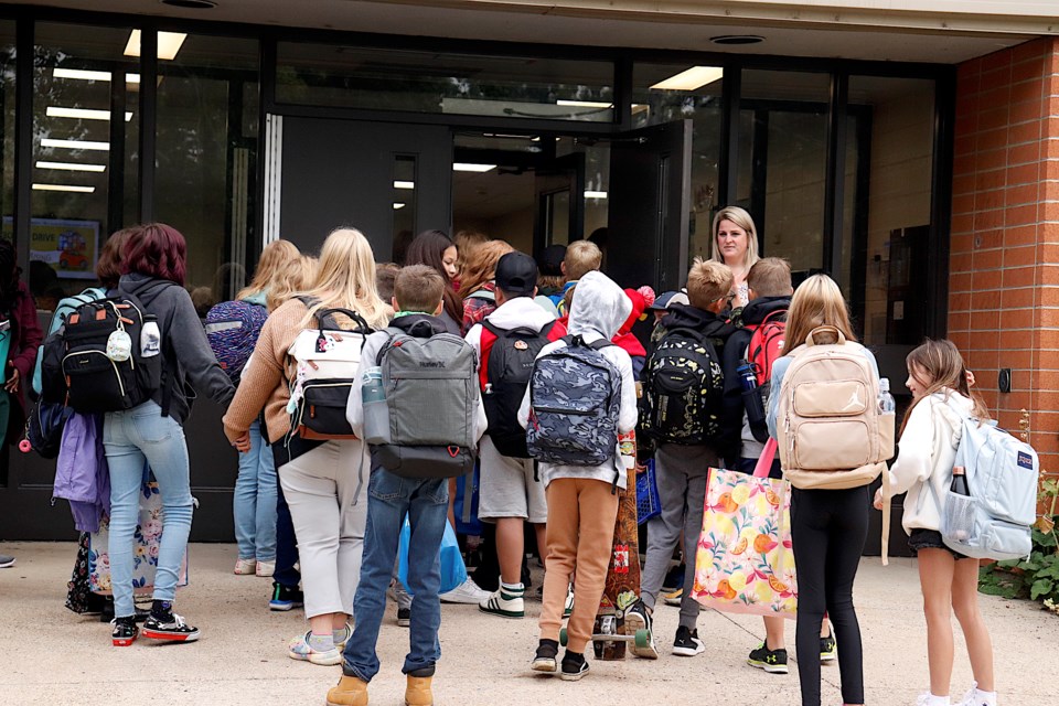 Crossfield area students returned to school from summer holidays on Sept. 5, and were excited to see their friends. Pictured: Students from Crossfield Elementary and W.G. Murdoch schools heading in for class.