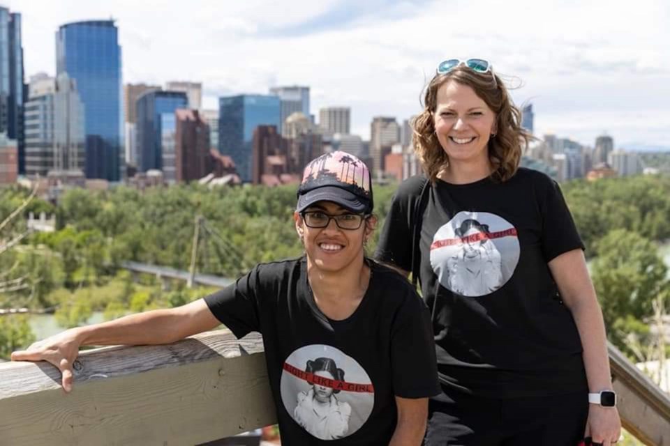 Airdrie resident Lovepreet Deo (left) and her trainer pose at the top of the McHugh Bluff stairs in Calgary. Deo, who has cerebral palsy, summited the 167 steps to celebrate her 40th birthday.