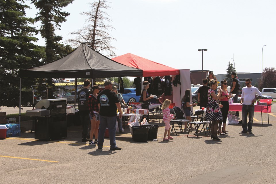 Calgary-based anti-abuse organization Against All Abuse presented a hot dog BBQ fundraiser in the parking lot next to No Frills in Airdrie on July 17. Photo by Carmen Cundy/Airdrie City View