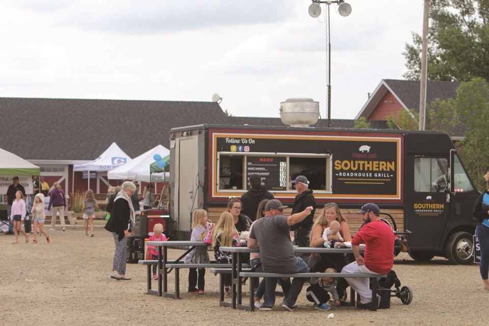 Patrons of Langdon Days enjoy a bite to eat from an assortment of food trucks at the event hosted by the Langdon Community Association on Aug. 21. Photo by Carmen Cundy/Rocky View Weekly