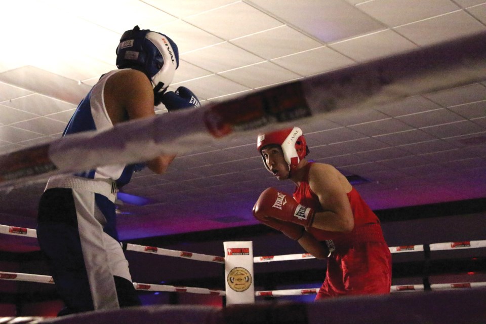 Two boxers go toe-to-toe at the Rumble at Humble boxing tournament held at the Town & Country Centre on June 17. Pictured are elite novice light heavyweights Nam Nguyen (right) of Dynamite Boxing Club and Nigel May-Rose of Bowmount Boxing Club.