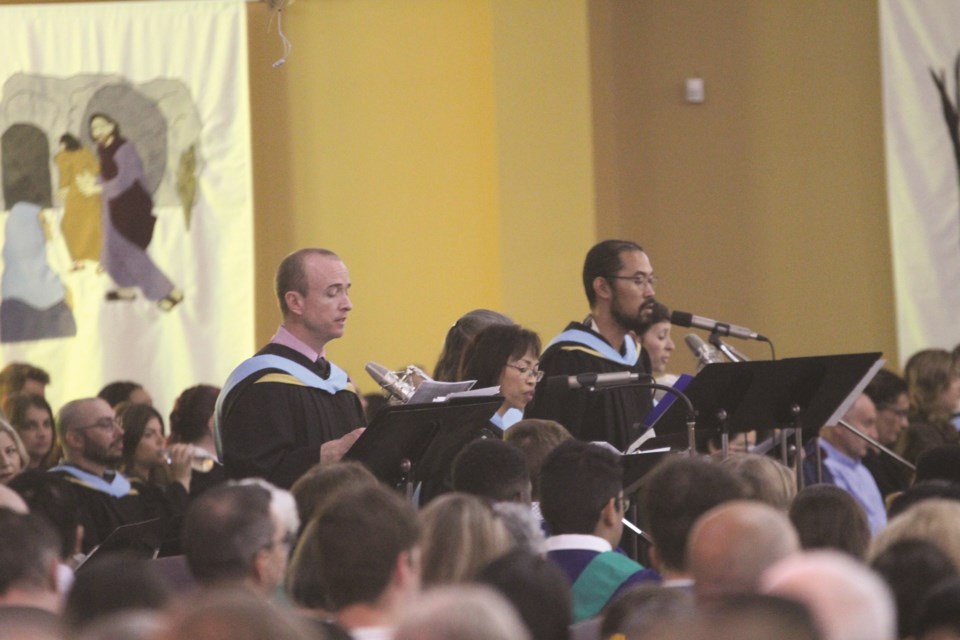 Performers take to the microphone during a mass at St. Paul's Catholic Parish in Airdrie prior to St. Martin de Porres 2022 convocation ceremony on May 27. 
