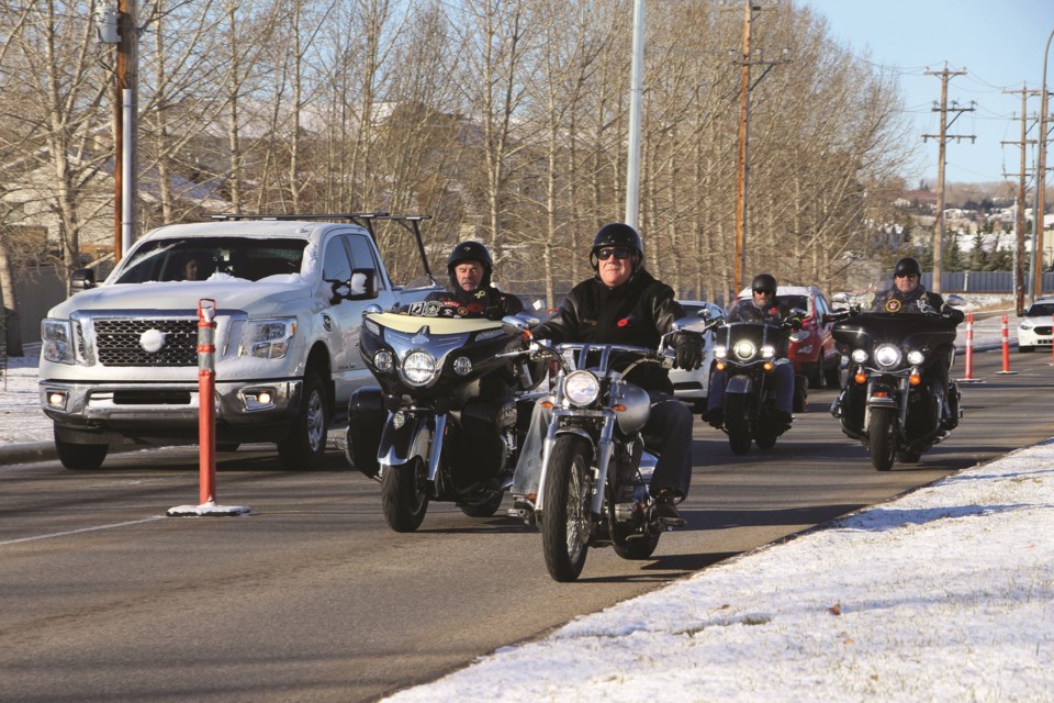 Mayor Peter Brown leads a motorcycle parade down Veterans Blvd. prior to the placing of white memorial crosses at the "Field of Honour" on Oct. 30, 2021.