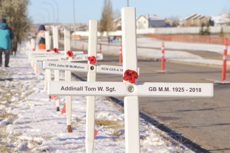 White crosses line the "Field of Honour" adjacent to Veterans Blvd. after the veterans parade ceremony on Oct. 30, 2021. 