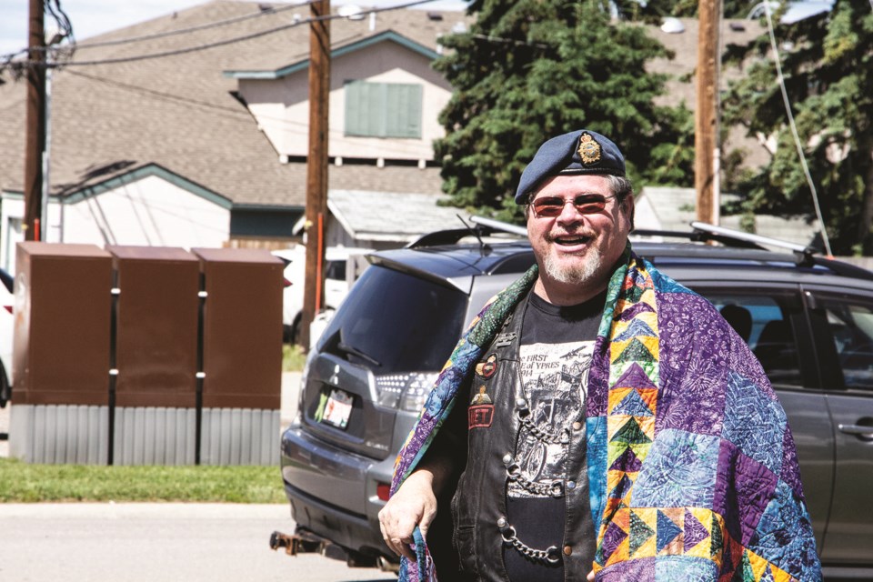 Veteran Norm McRae is all smiles while receiving his new quilt at the Airdrie Royal Canadian Legion July 5. The quilts were presented by Quilts of Valour. Photo by Jordan Stricker/Airdrie City View.
