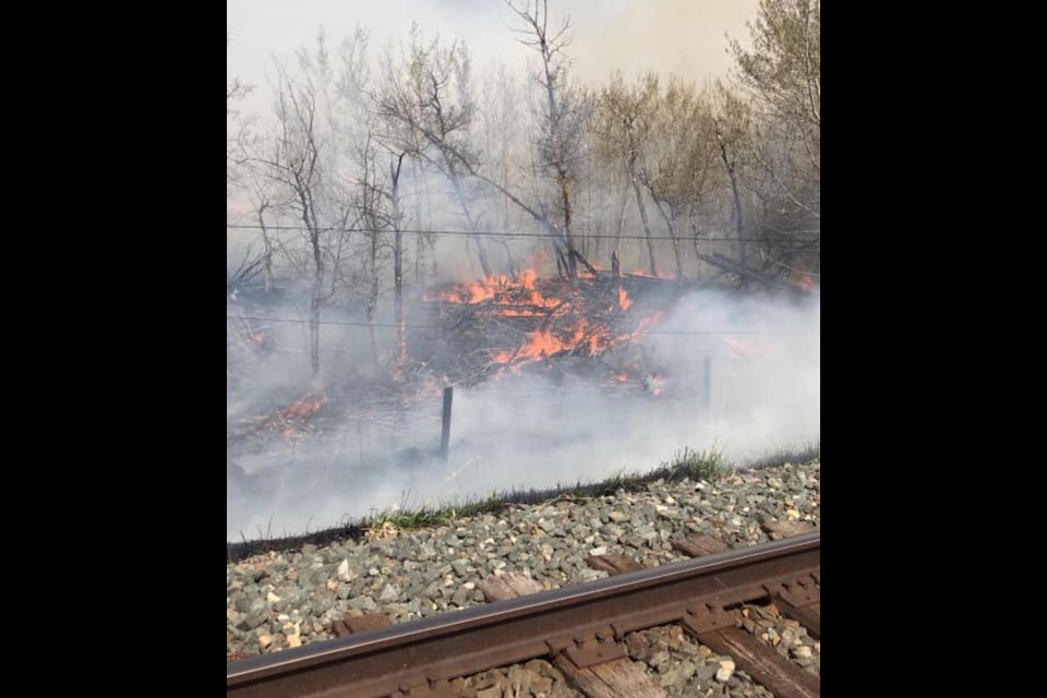 Photos posted to social media indicate the fire is burning near a local railway track.
