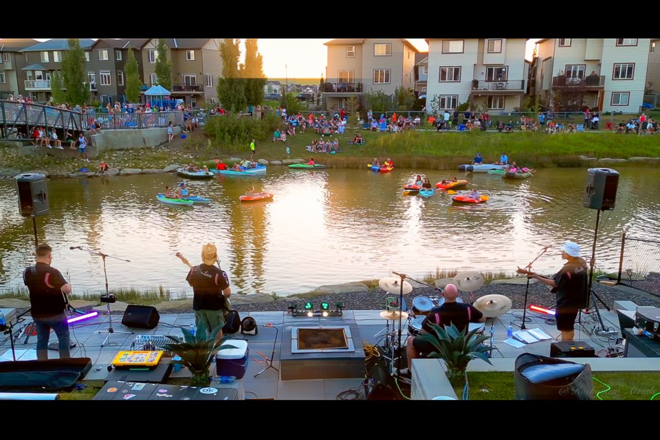 Attendees enjoy live music from their kayaks during the Bayside Rocks backyard concert in Airdrie.