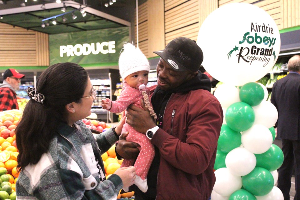 Melia Campos (left) and Dennis Aseh pose with their five-month-old daughter Zara at the Airdrie Sobeys on March 10. The couple recently won a $50,000 prize package as part of the Parent Life Network's Canada's Luckiest Baby contest.