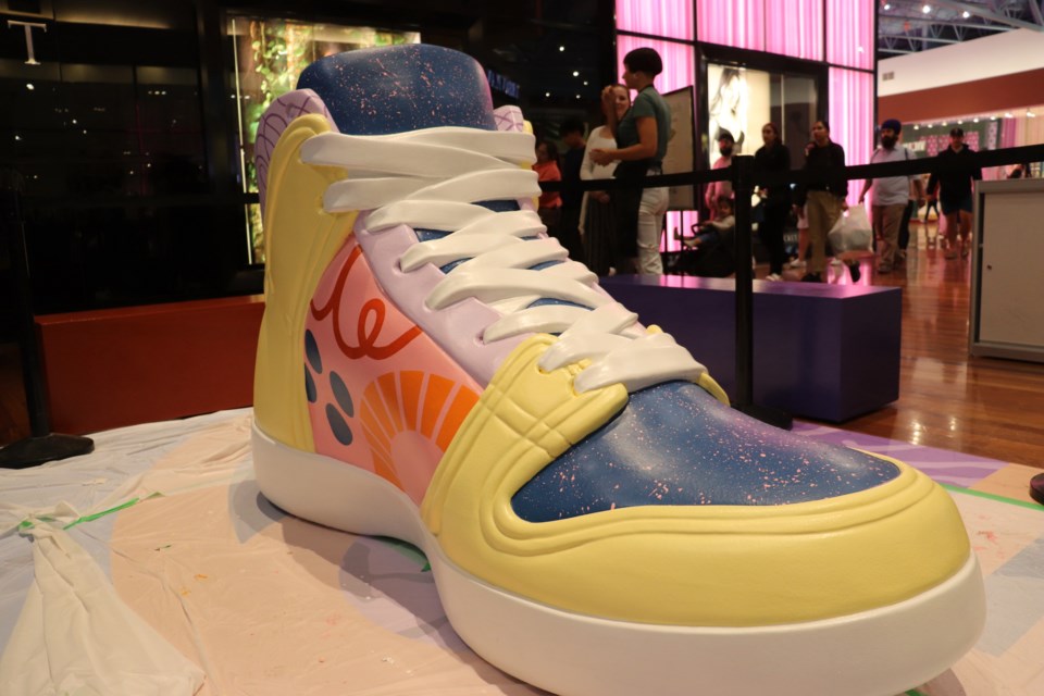 An eight-foot, larger-than-life sneaker is now set up at CrossIron Mills mall as part of the temporary Sole Scholars art installation.