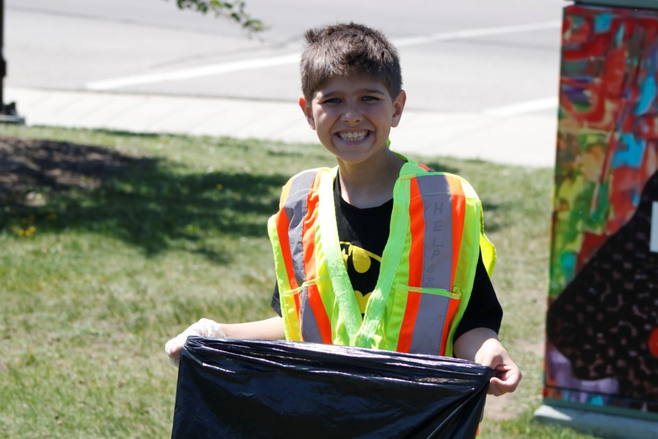 Students at Nose Creek Elementary School spent a sunny afternoon June 4 cleaning up garbage around the schoolyard and in the surrounding community. 
Photo by Nathan Woolridge/Rocky View Publishing