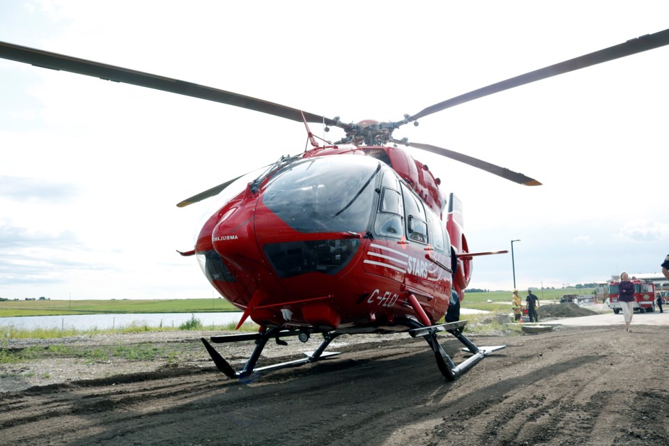 STARS Ambulance landed in a field near Rocky View County's breakfast and open house July 18 to unveil its new Rocky View County logo on the side of the helicopter. 
Photo by Nathan Woolridge/Rocky View Publishing