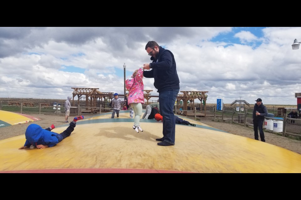 The chilly wind didn't keep people from attending the Baby Animal Festival May 20 at the Calgary Corn Maze and Fun Farm, located in Rocky View County along Township Road 224. Here, Lily can be seen jumping on the giant inflatable pillows with her dad, Joe.