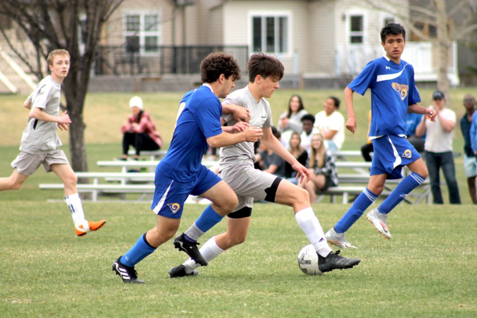 The Springbank Phoenix salvaged a draw with a late goal against the Bert Church Chargers in local high-school boys' soccer action on May 5. For a story, see page 14. Photo by Scott Strasser/Rocky View Weekly