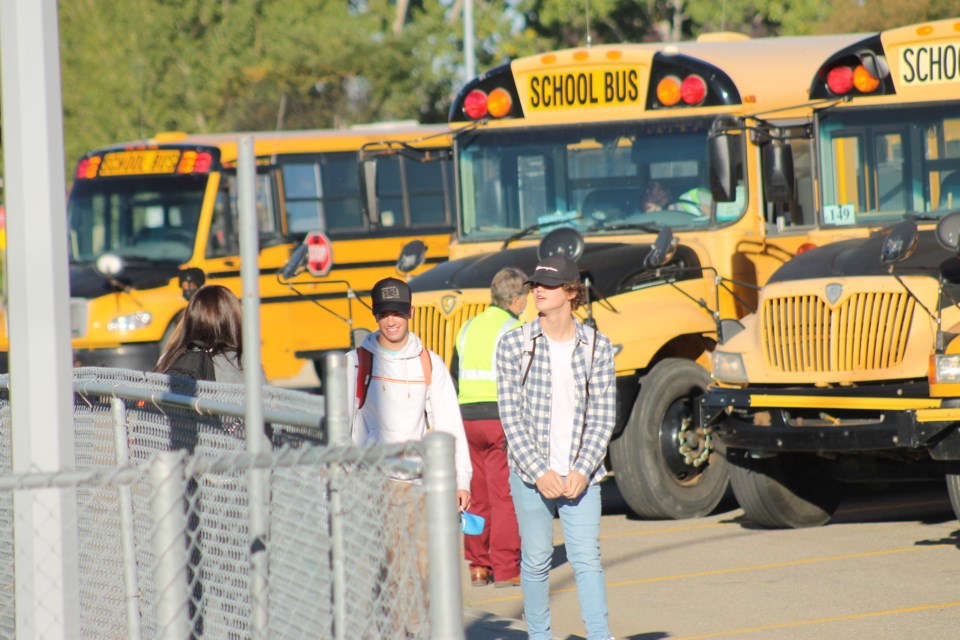 A row of yellow school buses is visible in the parking lot of the Airdrie Town and Country Centre in the morning of Sept. 7 – the first day back in class for public school students in Airdrie. Photo by Scott Strasser/Airdrie City View