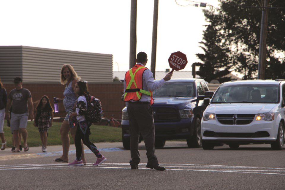 Parents drop their kiddos off for their first day of school at Crossfield Elementary School on Sept. 1.