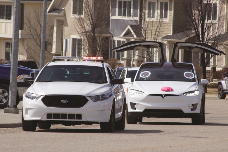 Teachers and staff from Heloise Lorimer School formed a procession of decorated vehicles April 9 and paraded through the neighbourhoods of Ravenswood and King's Heights to show their students how much they were missed.
Photo by Ben Sherick/Airdrie City View