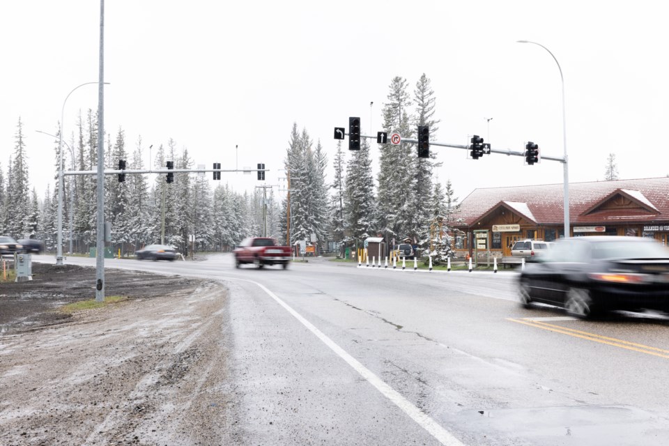 Motorists pass under the new traffic lights at Bragg Creek's four-way intersection on May 20. 