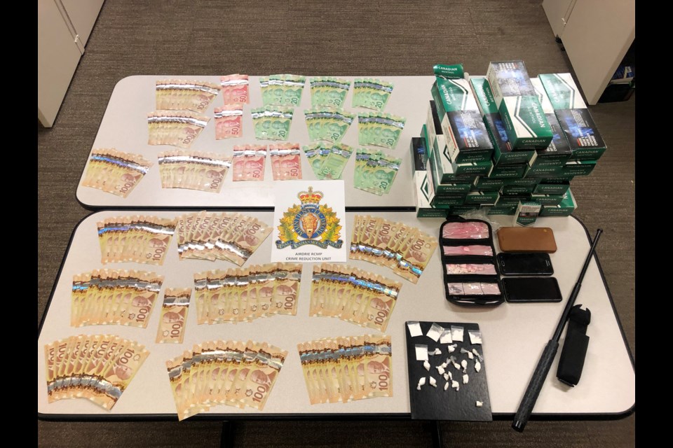 Airdrie RCMP seized cocaine, fentanyl, $14,260 cash, a police baton and more than 5,000 cigarettes with un-stamped tobacco July 21. A 32-year-old male and a 31-year-old female were arrested. 
Photo Submitted/For Rocky View Publishing