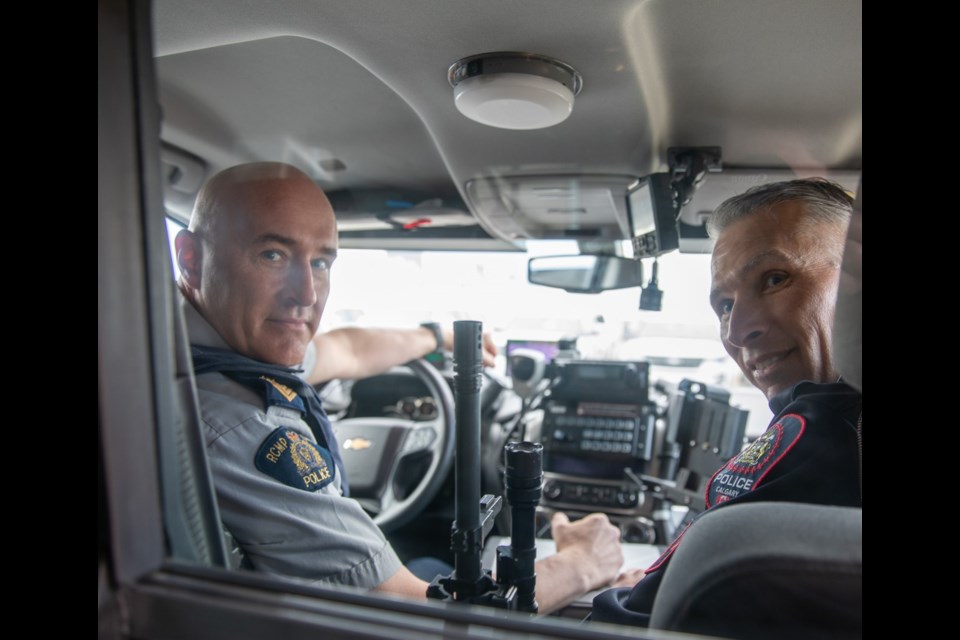 Airdrie RCMP Sgt. Jeff Campbell (left) got to enjoy some quality family time during his final shift with the detachment on May 9, as he was joined for a surprise ride-along by his brother Derrick, a fellow police officer with Calgary Police Service.