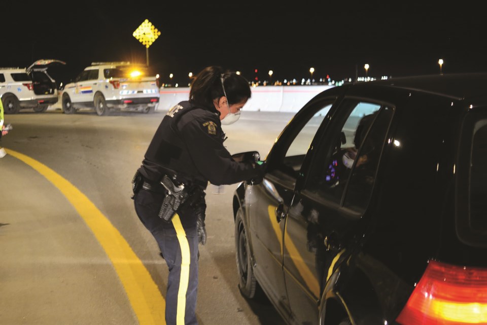 Alberta RCMP officers conducted multiple check stops Dec. 5, including this one in Airdrie. RCMP is reminding people that check stops will continue to take place this holiday season, despite a ban on social gatherings. 