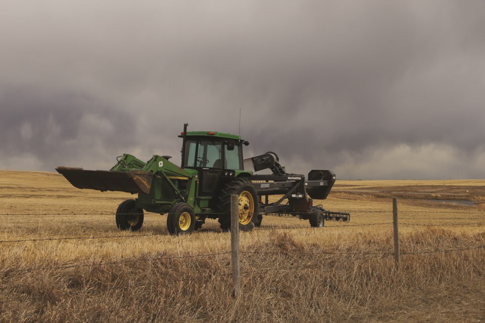 An off-duty tractor is parked on a farmer's property just off of Panorama Road, west of AIrdrie.