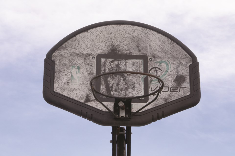 A basketball hoop in an alley just off of 24 Street in Airdrie shows years of good use.