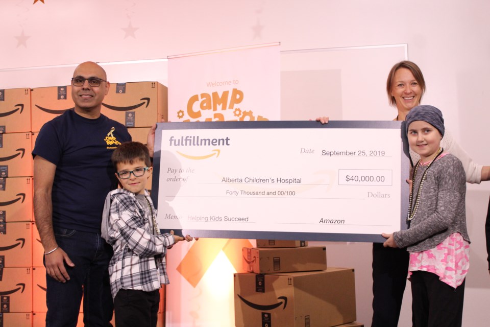 Amazon YYC general manager Jas Khangura (left) and Alberta Children’s Hospital Foundation rep Melanie Sortland (second from right) unveil Amazon’s $40,000 cheque to the ACHF, Sept. 25, alongside two members of Camp Amazon.
Photo by Scott Strasser/Rocky View Publishing