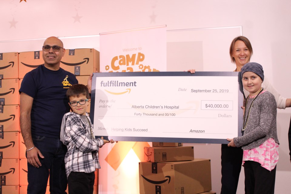 Amazon YYC general manager Jas Khangura (left) and Alberta Children’s Hospital Foundation rep Melanie Sortland (second from right) unveil Amazon’s $40,000 cheque to the ACHF, Sept. 25, alongside two members of Camp Amazon.
Photo by Scott Strasser/Rocky View Publishing