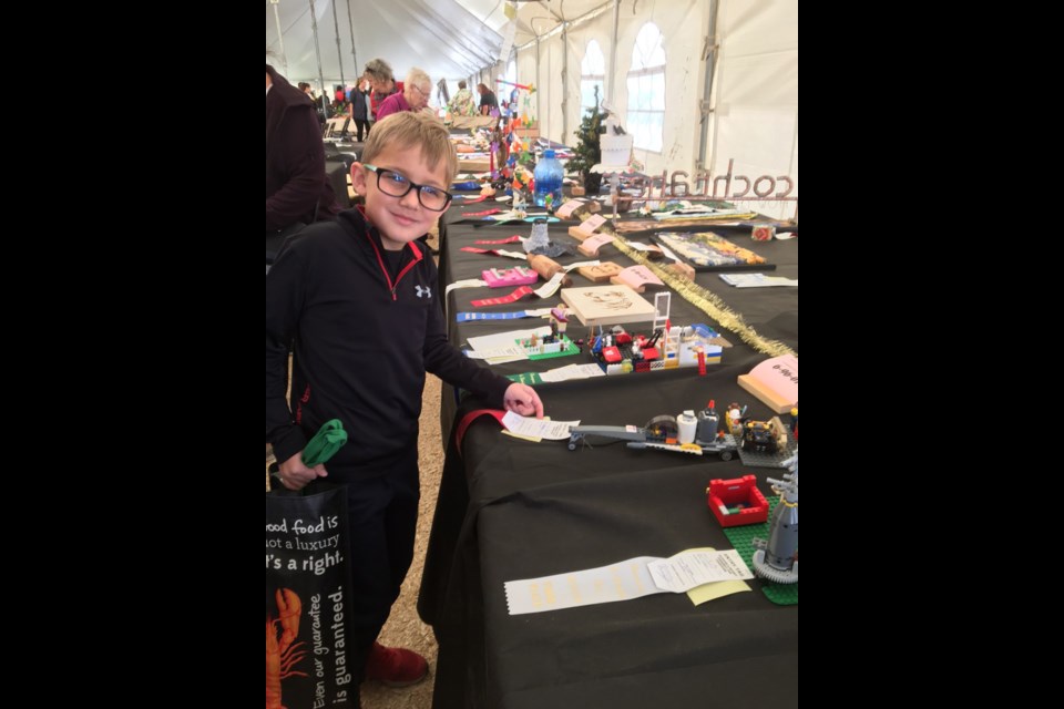 Bearspaw Old Tyme Country Fair attendee Mason Britton enjoyed checking out the available wares at the 50th rendition of the annual event in August 2018. 
Photo Submitted/For Rocky View Publishing