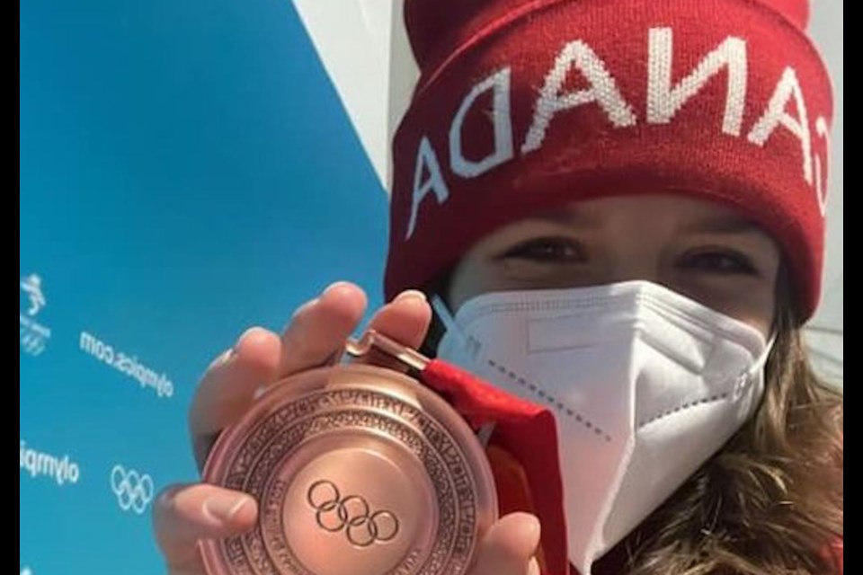 Abigail Strate poses with her bronze medal, which she earned at the Beijing Winter Olympics as a member of Canada's mixed ski jump team.