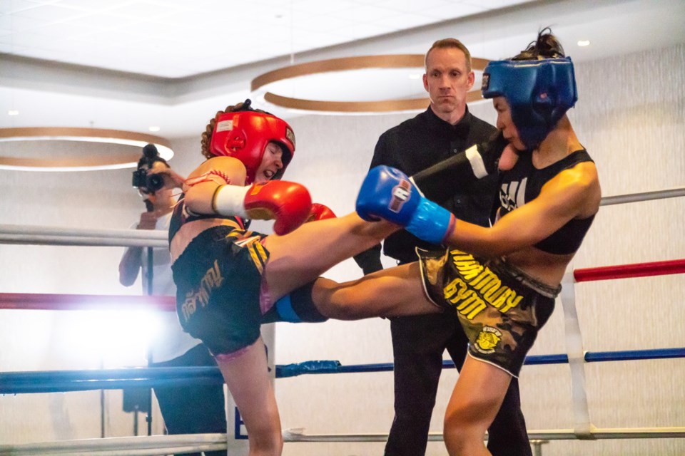 Airdrie's Emily Vigneault (left) lands a kick on Abigail Alerta, the national Muay Thai champion for the girls novice age 11-12 junior middleweight division, May 11 at the Trial by Fire 8 martial arts showcase. Vigneault went on to win the match.
Photo Submitted/For Rocky View Publishing