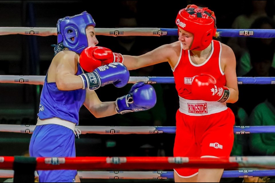 Airdrie boxer Emily Vigneault (red) lands a punch on her opponent at the Canada Winter Games in P.E.I.