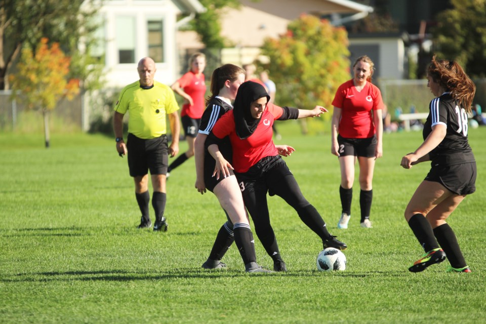 The Chestermere Lakers (red) kicked off the 2019 RVSA girls' soccer season Sept. 12 with a 3-2 win over the George McDougall Mustangs. 
Photo by Scott Strasser/Rocky View Publishing