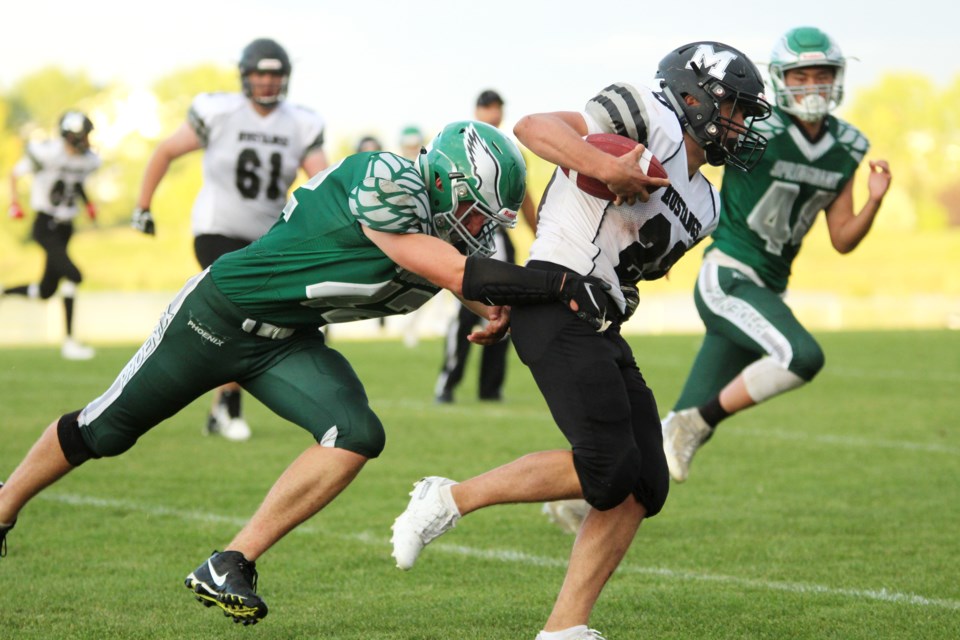 The George McDougall Mustangs kicked off the 2019 high-school football season with a 44-6 loss to the Springbank Phoenix. Photo by Scott Strasser/Rocky View Publishing