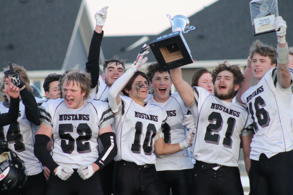 George McDougall Mustangs players celebrate with the trophy after beating the Cochrane Cobras on Oct. 28 – their first RVSA banner victory since 2014.