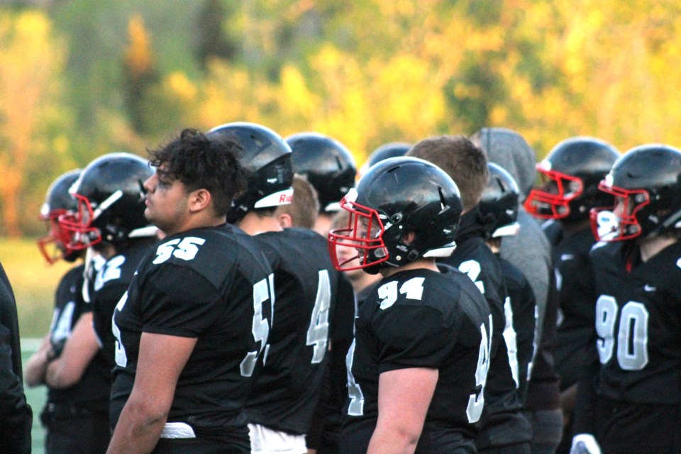 Airdrie Raiders players watch on as the Calgary Cowboys celebrate winning the Calgary Spring Football Association Division 1 title on May 27.