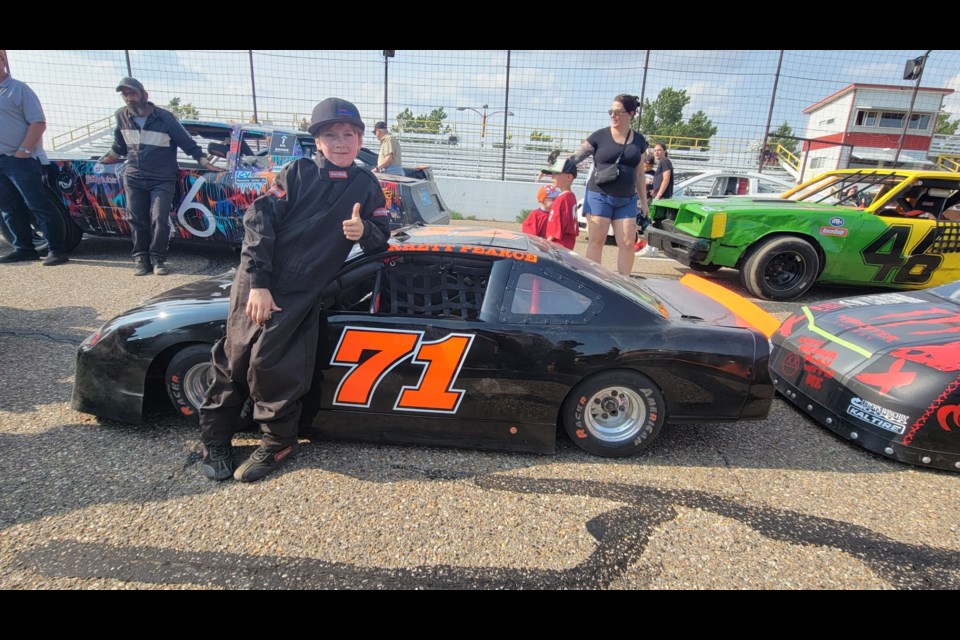 Rhett Pearce poses next to his car at a recent race in Medicine Hat.