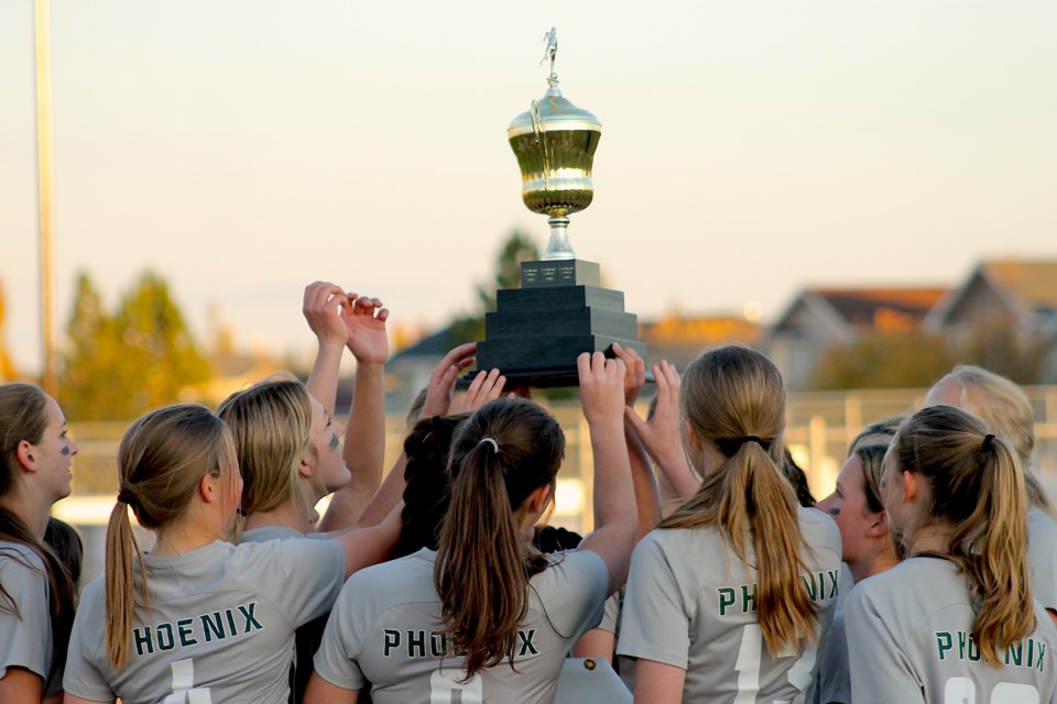 Springbank players hoist the Rocky View Sports Association trophy aloft on Oct. 20, after shutting out the Cochrane Cobras 6-0.