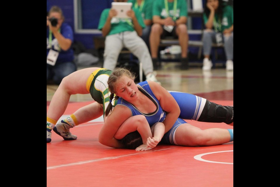 Zoë Adam puts her opponent into a hold. 
Photo: Cochrane Cowboys Wrestling Club
