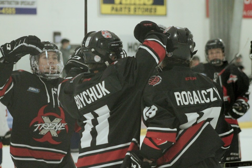Airdrie Xtreme players celebrate after scoring a goal against the Lethbridge Golden Hawks on Oct. 17.