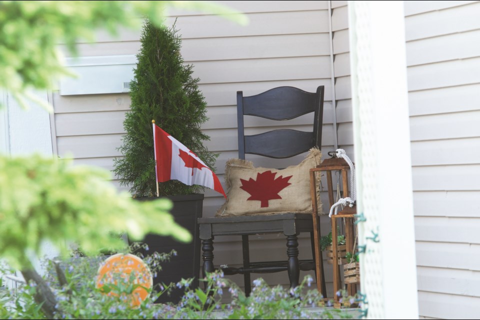 Airdrie Parade Committee hosted the inaugural Canada Day Home Decorating Contest July 1. The residents of this house in the Canals set up a Canada flag and pillow on their porch. Photo by Scott Strasser/Airdrie City View.