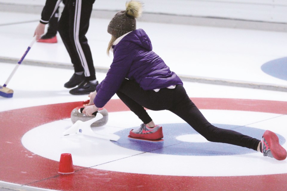 W.G. Murdoch High School students in grades 7 to 12 participated in a learn-to-curl clinic Jan. 23 at the Crossfield Curling Club. Two-time Canadian women's champion Heather Nedohin led the clinic. Photo by Scott Strasser/Rocky View Weekly