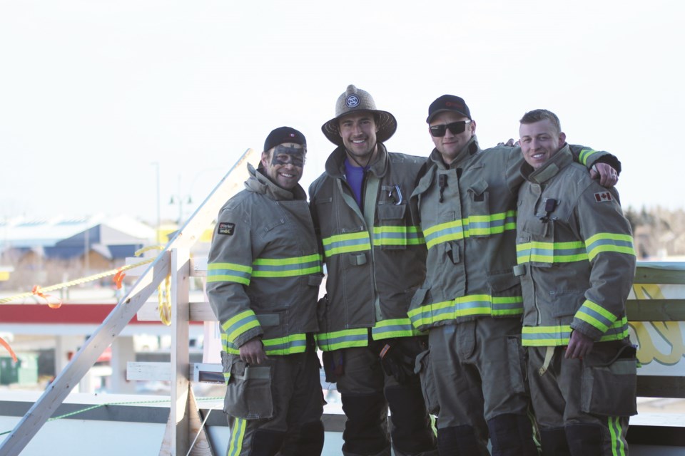 The seventh annual Airdrie Firefighters Rooftop Campout took place Feb. 19 to 22 at the Toad 'n' Turtle Pubhouse & Grill. 
(Left to right) Travis Smutt, Isaiah Hoeppner, Justin Furhiman and Billy Dowling were the four Airdrie Fire Department firefighters Four members who camped on the pub’s roof for 72 hours to raise money for Muscular Dystrophy Canada. Photo by Scott Strasser/Airdrie City View