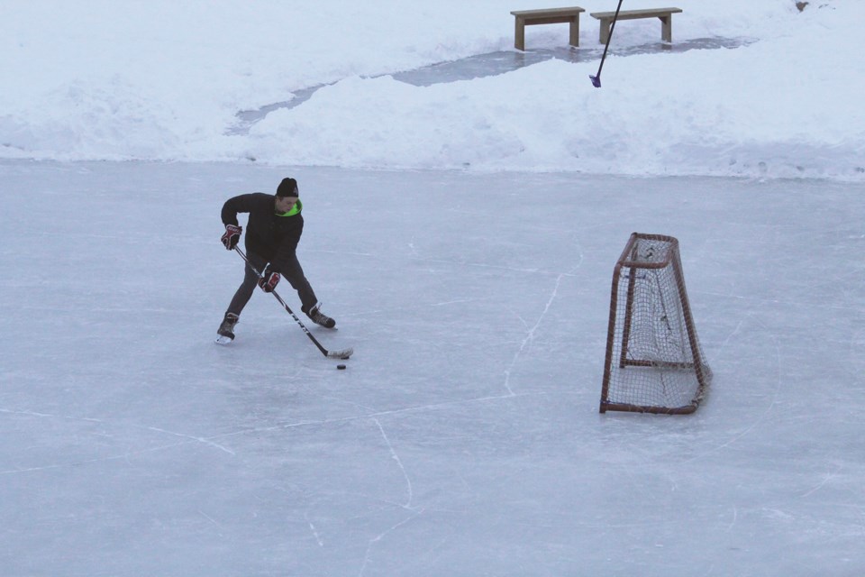 An Airdrie hockey player works on his shooting on one of the frozen canals in Bayside, Dec. 30.