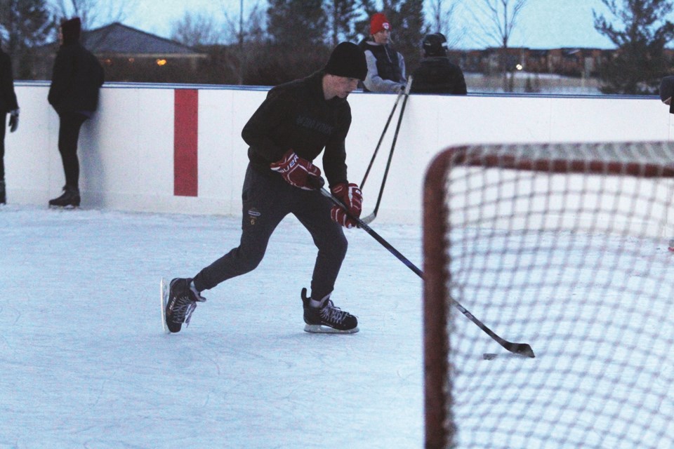 A hockey player practises his shooting at the Chinook Winds Regional Park outdoor rink, Dec. 18. 