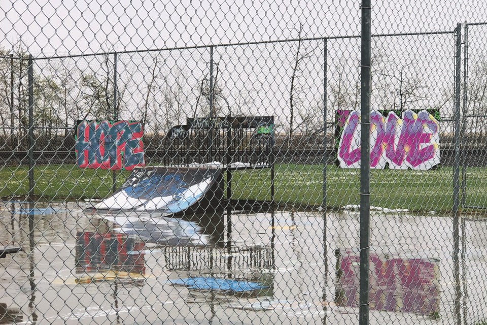 Two graffiti signs reading "Hope" and "Love" are  seen at the Crossfield skate park during a rainy Saturday afternoon.